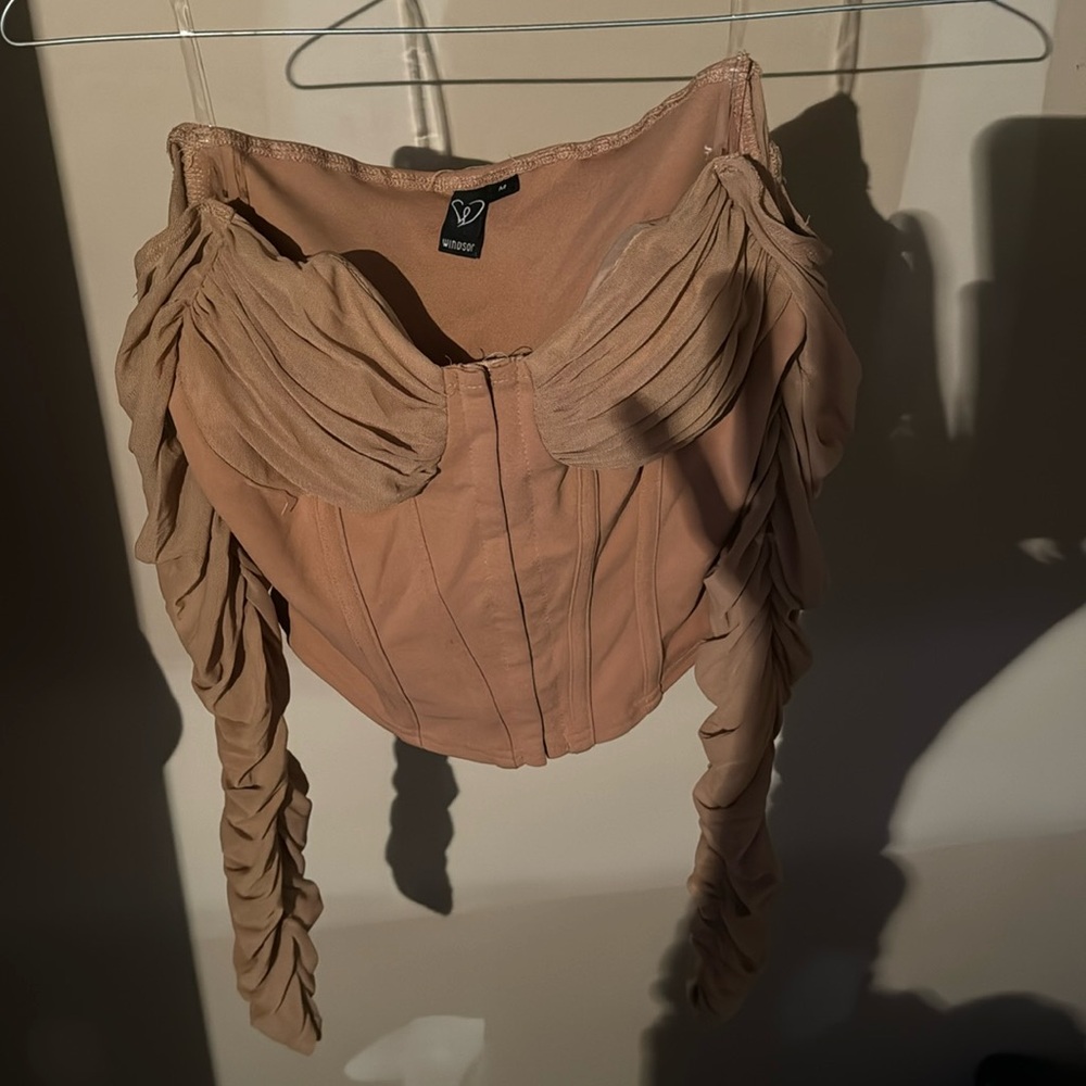 Nice top for a night out . Nice tan/nude looking color matches almost anything !